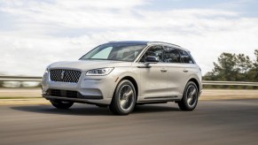 A white 2022 Lincoln Corsair is driving on the road.