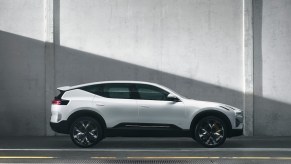 A white Polestar 3 parked in front of a white wall.