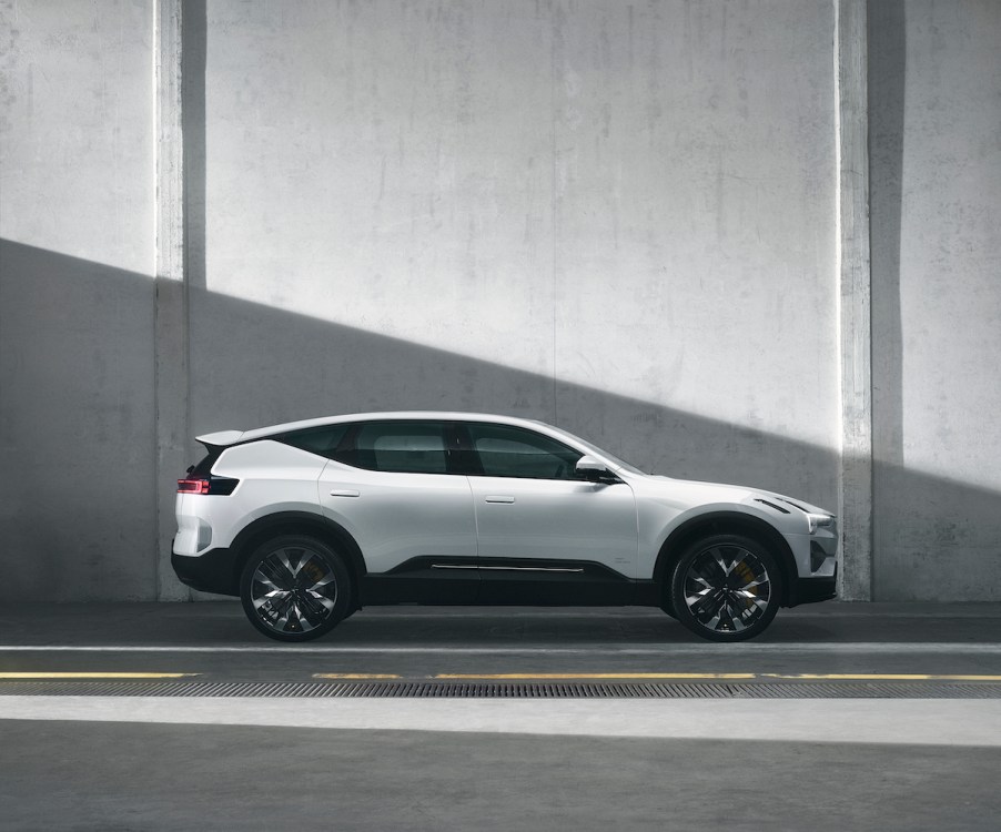 A white Polestar 3 parked in front of a white wall.