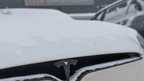 A white Tesla with Cold Weather Driving Range in an EV.