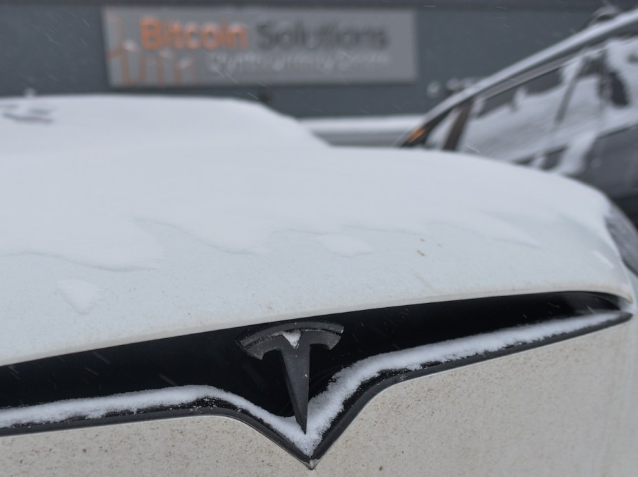 A white Tesla with Cold Weather Driving Range in an EV. 