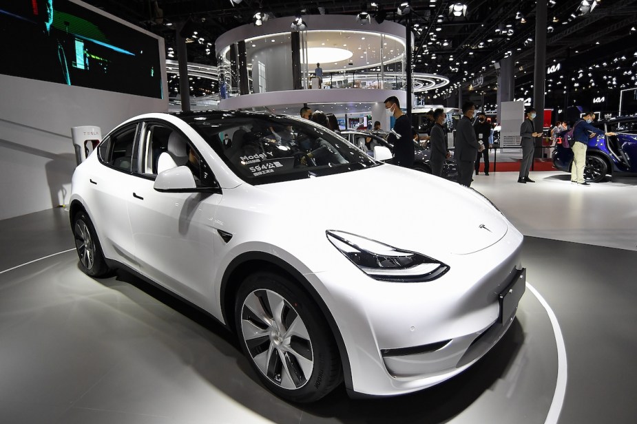 A white Tesla Model Y parked indoors. 