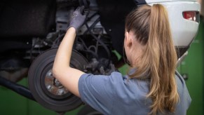 A mechanic potentially working on the car with the cheapest 10-year maintenance.