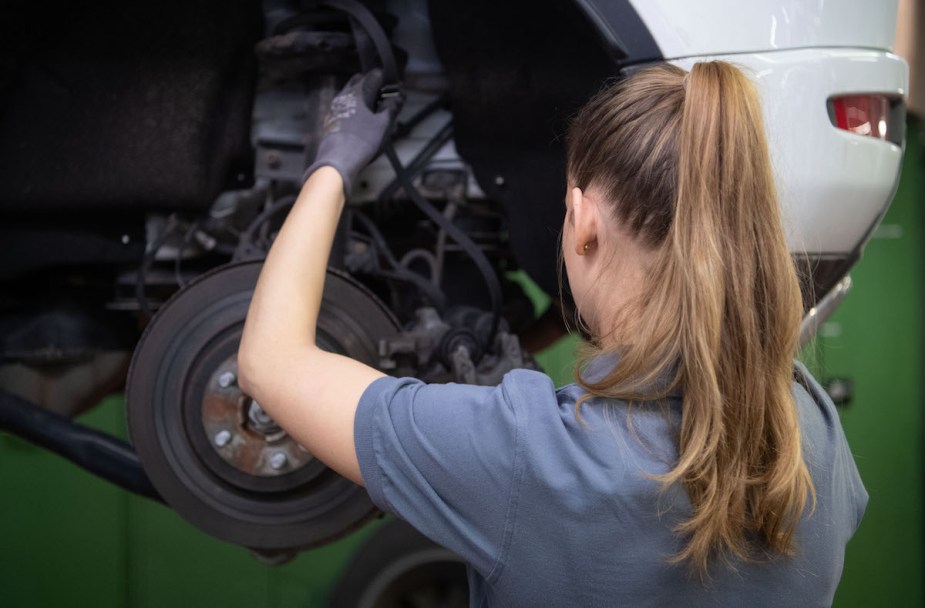 A mechanic potentially working on the car with the cheapest 10-year maintenance. 