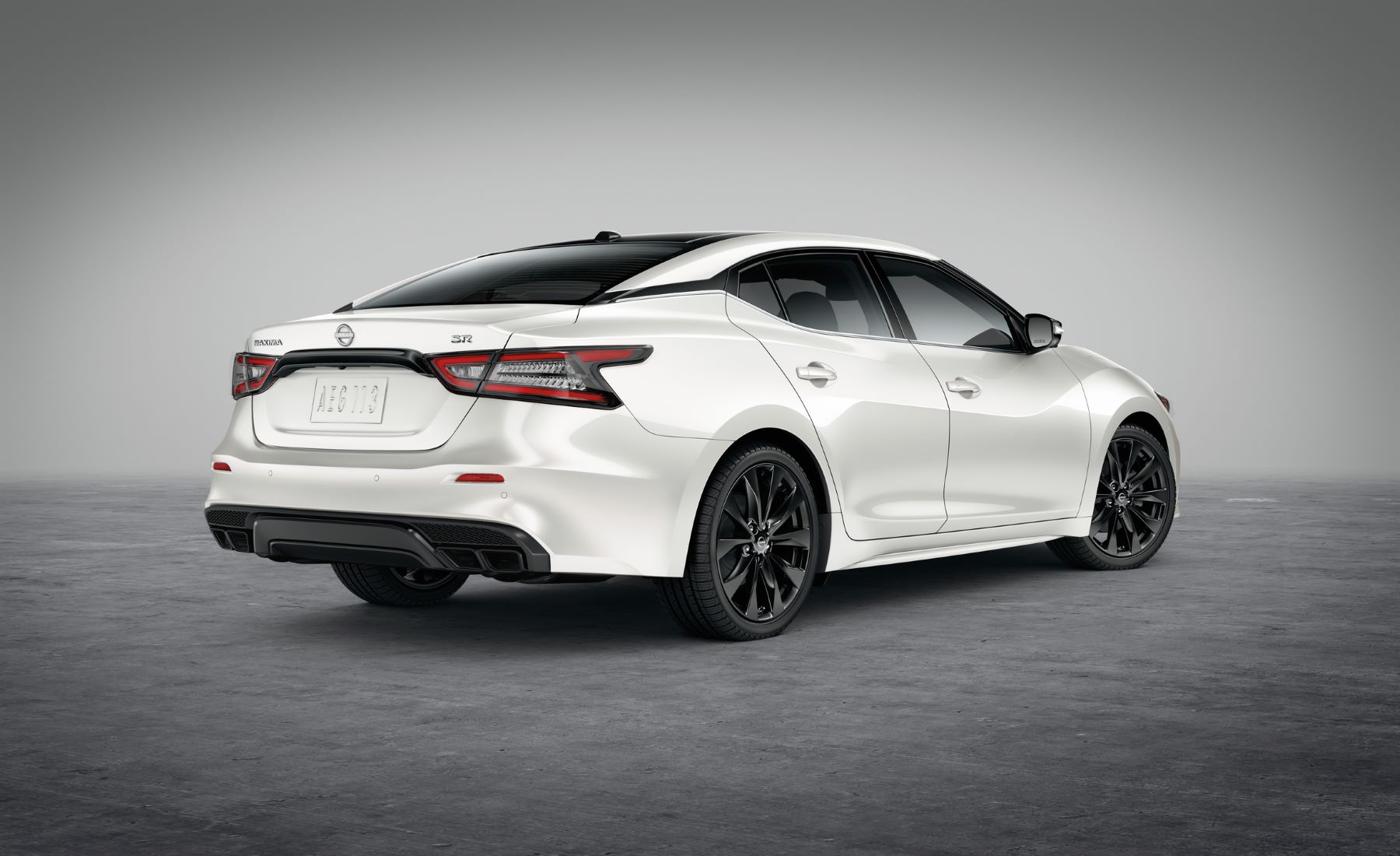 A promotional rear shot of a white 2023 Nissan Maxima midsize sedan