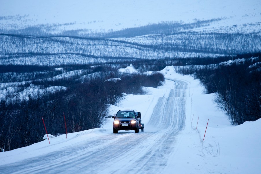 A car towing during winter on a snow covered road.