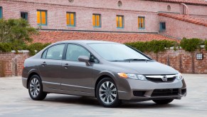 A light grey 2009 Honda Civic parked in front of a building