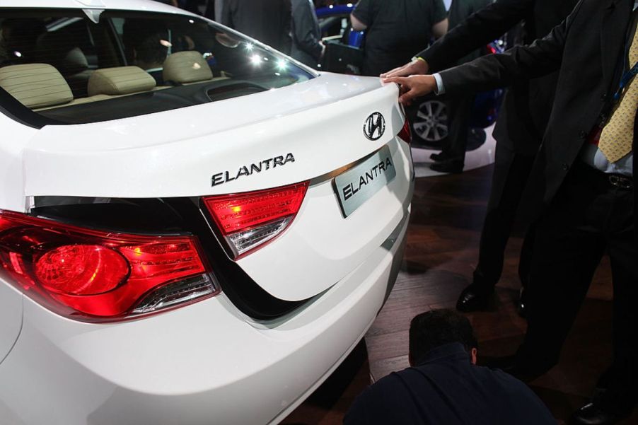 A white 2012 Hyundai Elantra on display at an auto show.