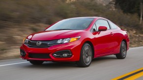 A red 2014 Honda Civic Coupe driving