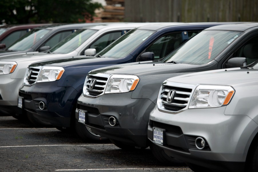 A group of 2015 Honda Pilot three-row SUVs sits on display.