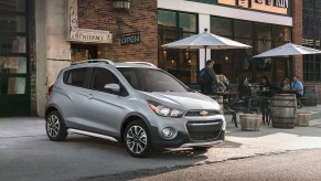 A silver Chevy Spark, which is one of the vehicles with the lowest maintenance costs.