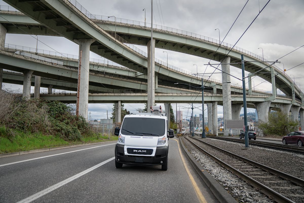 A 2021 Dodge Ram ProMaster van driving down a highway