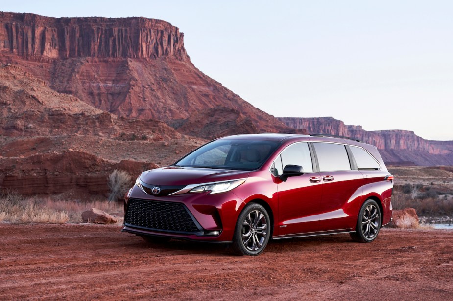 A red off-road Toyota Sienna parked outdoors. 