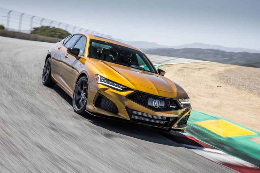 An orange 2022 Acura TLX driving on a track.