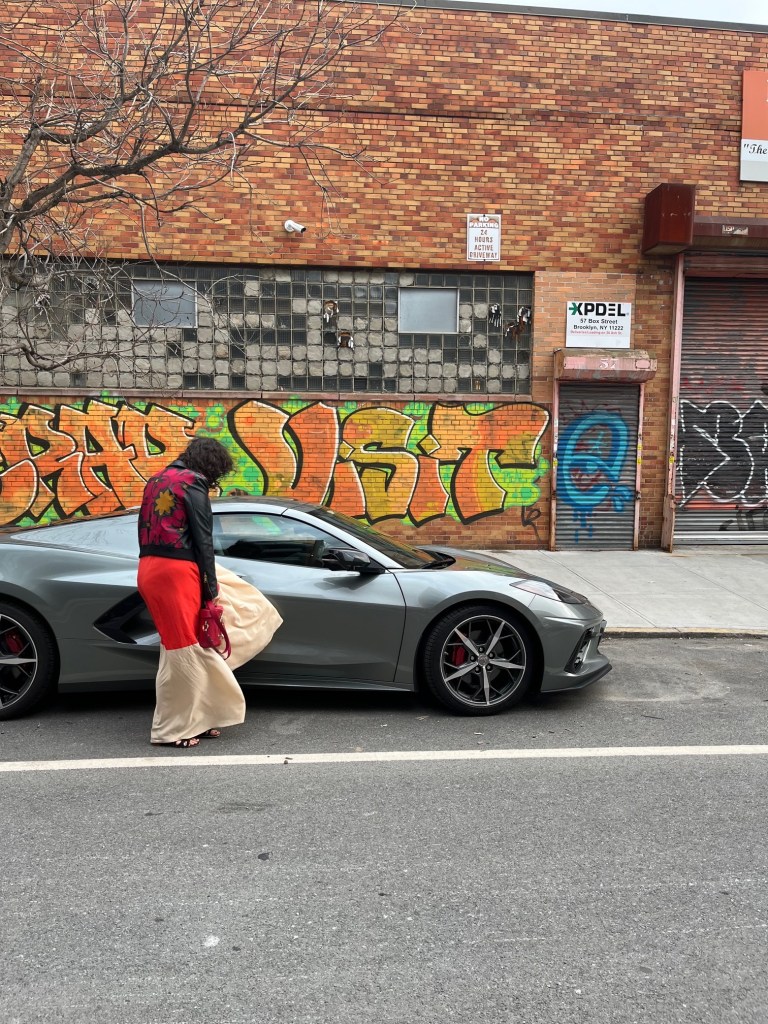 MotorBiscuit Car of the year:2022 Chevrolet C8 Corvette with woman in front