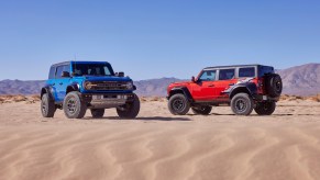 A red and blue Ford Bronco in the desert.