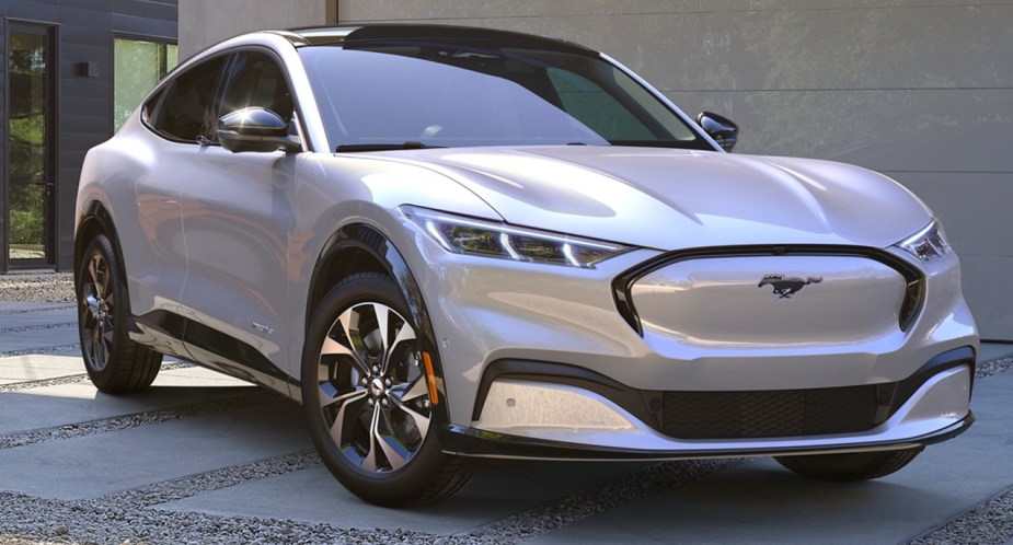 A gray 2022 Ford Mustang Mach-E small electric SUV is parked. 