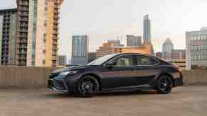 A Black 2022 Toyota Camry midsize sedan parked in a parking garage