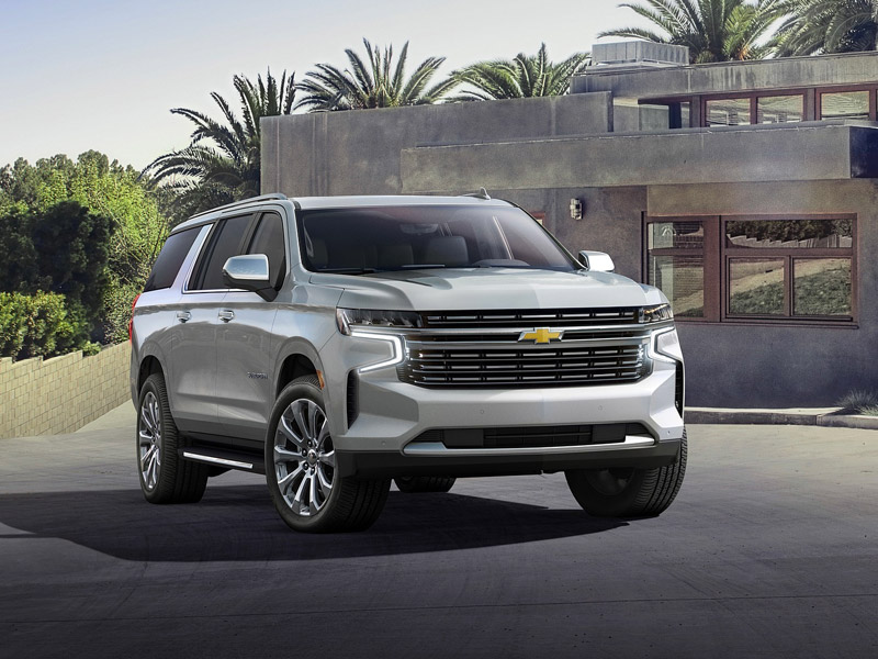 The 2023 Chevy Suburban parked near a home