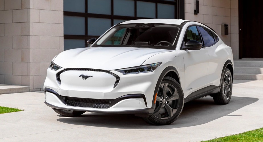 A white 2023 Ford Mustang Mach-E small electric SUV is parked. 