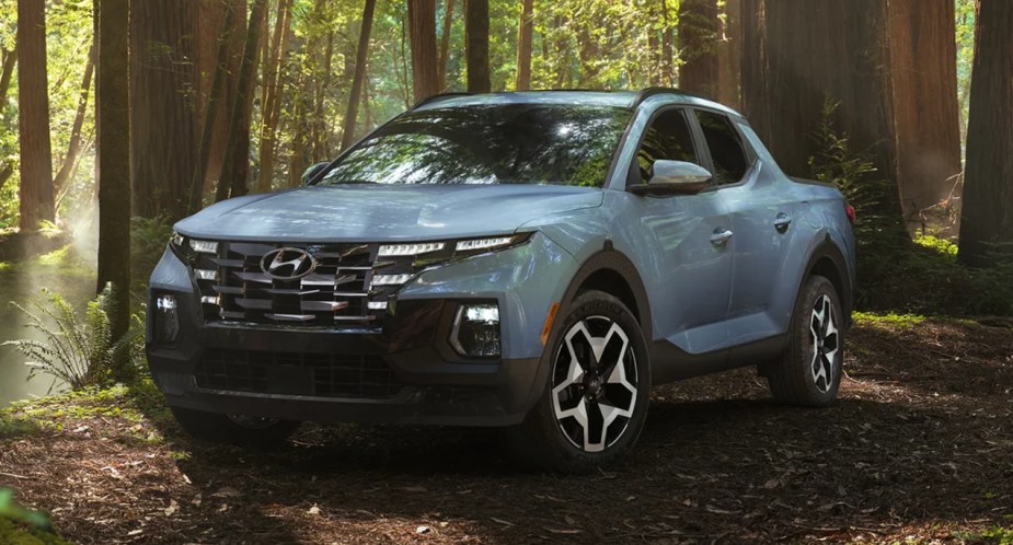 A blue 2023 Hyundai Santa Cruz small pickup truck is parked outdoors.