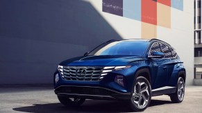 A blue 2023 Hyundai Tucson Hybrid small hybrid SUV is parked.