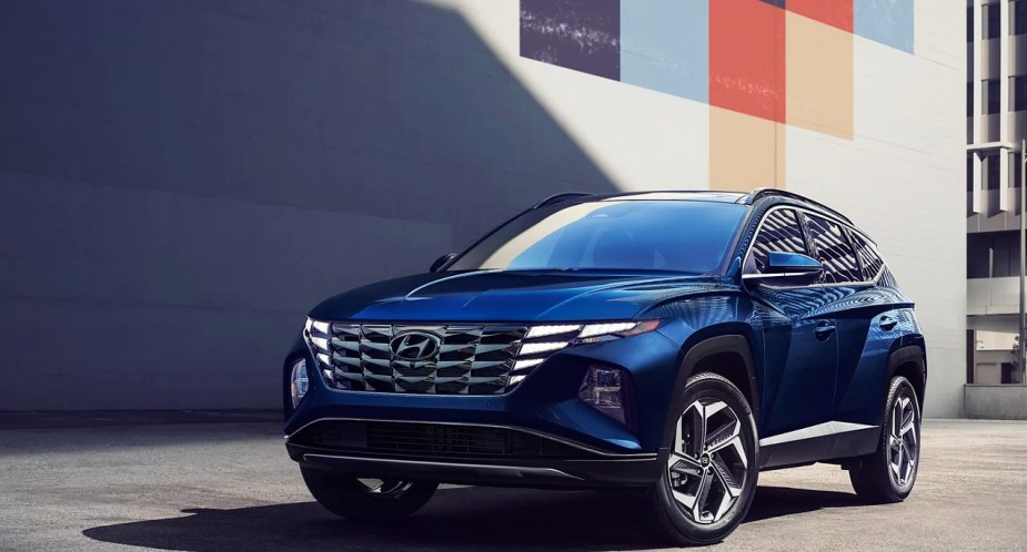 A blue 2023 Hyundai Tucson Hybrid small hybrid SUV is parked. 