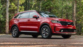 A red 2023 Kia Sorento hybrid midsize SUV is parked.