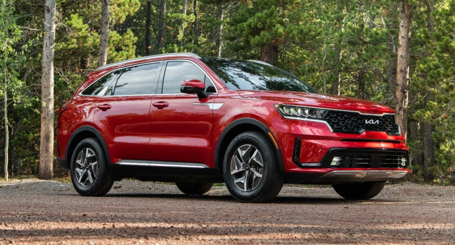 A red 2023 Kia Sorento Hybrid midsize hybrid SUV is parked. 