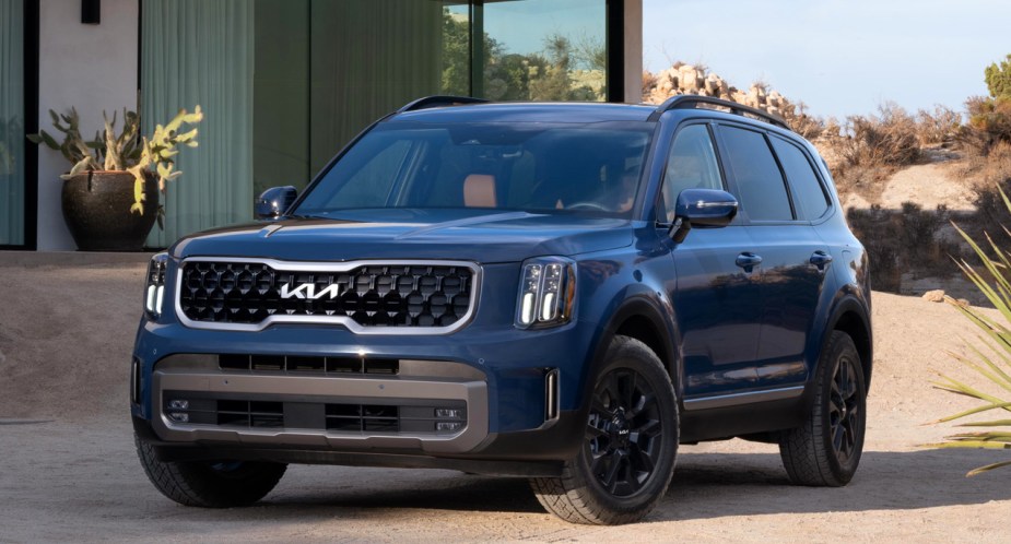 A blue 2023 Kia Telluride midsize SUV is parked outdoors. 