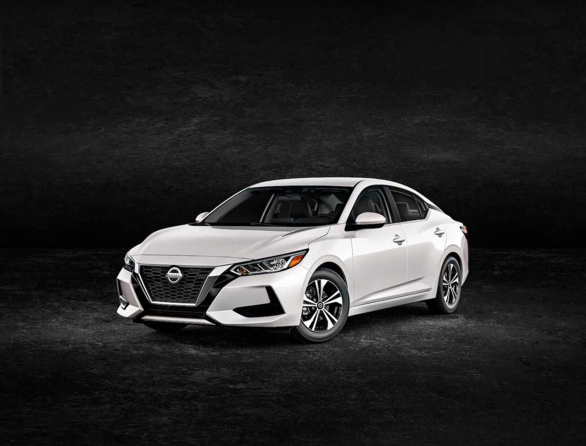 White Nissan Sentra against a black background.