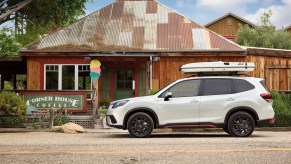 A white 2023 Subaru Forester parked outside a home, which is one of the best new small SUV under $30,000