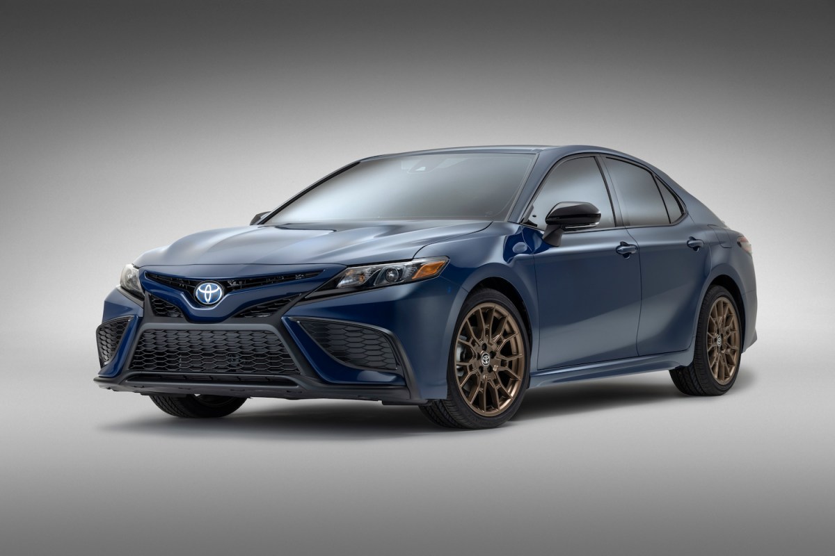 A 2023 Toyota Camry parked against a grey backdrop