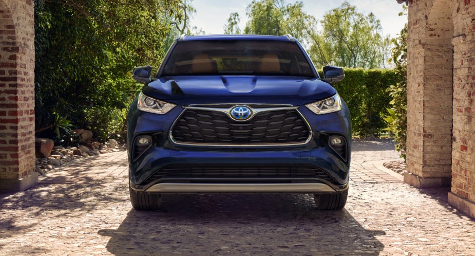 A blue 2023 Toyota Highlander Hybrid midsize hybrid SUV is parked.