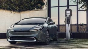 A 2023 Toyota Prius Prime charging in a driveway.