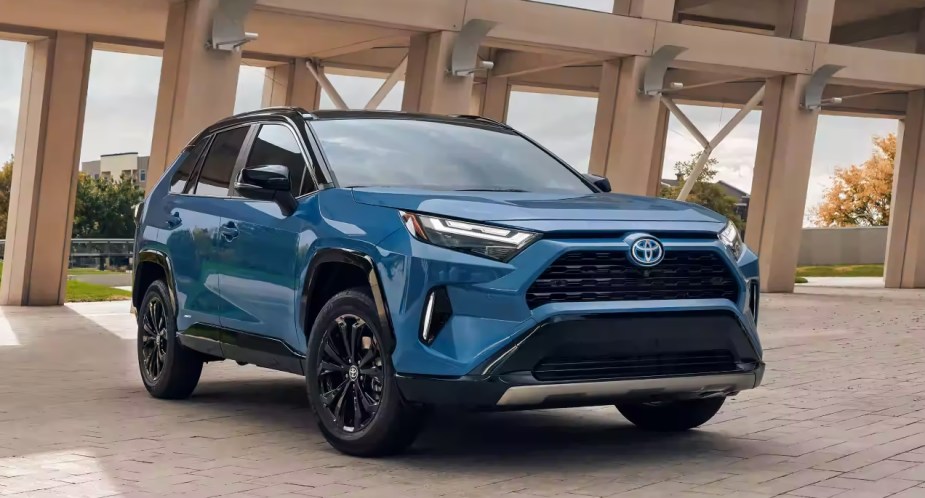 A blue 2023 Toyota RAV4 Hybrid small SUV is parked. 