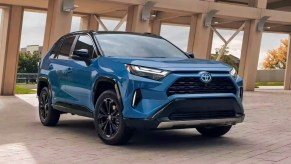 A blue 2023 Toyota RAV4 Hybrid small SUV is parked.