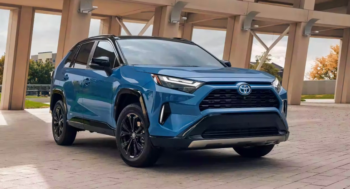 A blue 2023 Toyota RAV4 Hybrid small SUV is parked.