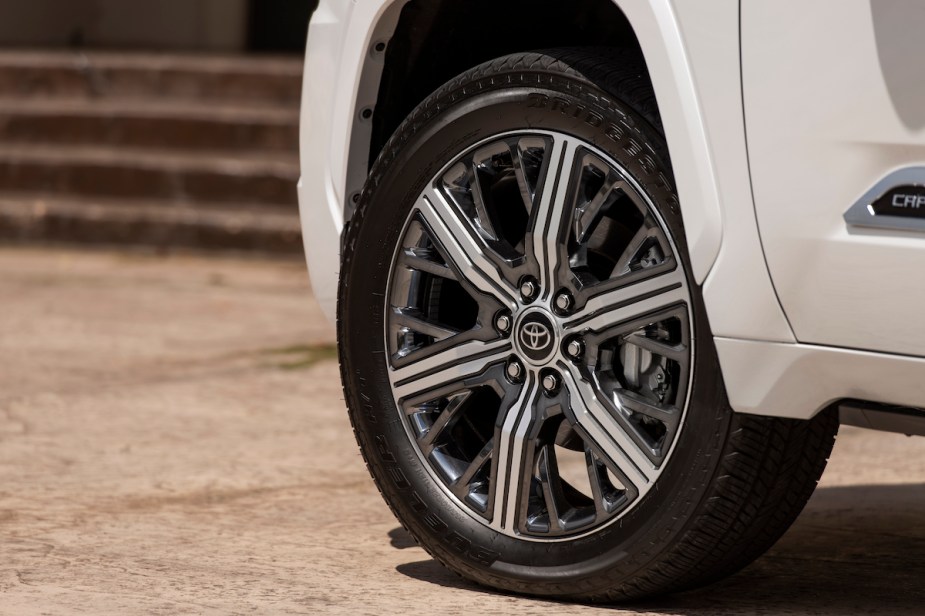 The wheel of a white 2023 Toyota Sequoia with the cheapest 5-year ownership costs. 