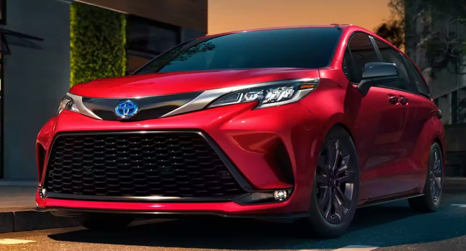 A red 2023 Toyota Sienna minivan is parked. 