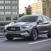 a gray 2023 Infiniti QX50 luxury compact SUV driving on a road, experts agree on the best trim.