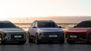 Three Hyundai Kona subcompact SUVs are parked.