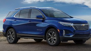 A blue 2023 Chevrolet Equinox small SUV is parked.