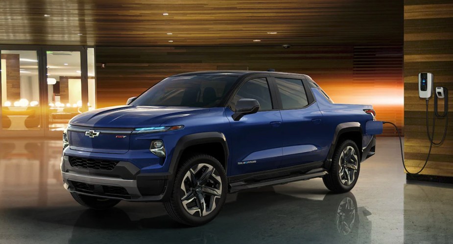 A blue 2024 Chevrolet Silverado EV is parked indoors.