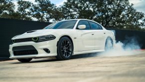 A white Dodge Charger spinning its wheels, showing off just how much horsepower it actually has