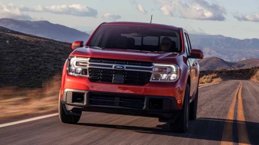 Front angle view of red 2023 Ford Maverick pickup truck, the cheapest new Ford car