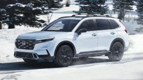 Front angle view of white 2023 Honda CR-V crossover SUV, rivaling the Hyundai Tucson.