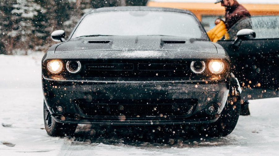 Front view of snowy car, showing how warm with engine block heater in cold weather is better than idling