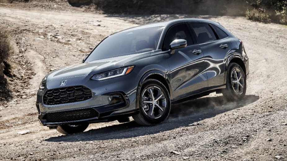 Gray 2023 Honda HR-V crossover SUV driving on a gravel road