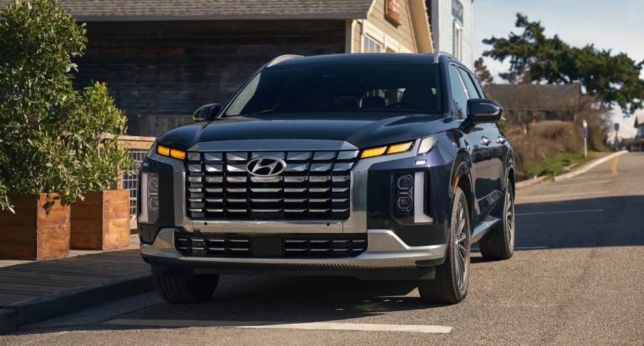 A blue 2023 Hyundai Palisade midsize SUV is parked. 